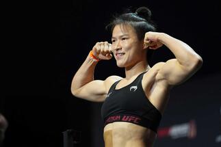 Zhang Weili of China poses on the scale during the UFC 281 ceremonial weigh-in at Radio City Music Hall on November 11, 2022 in New York City